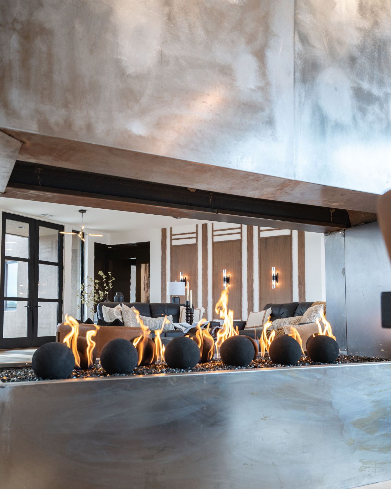 Modern office interior with a long linear gas fireplace integrated into a sleek white wall design.
