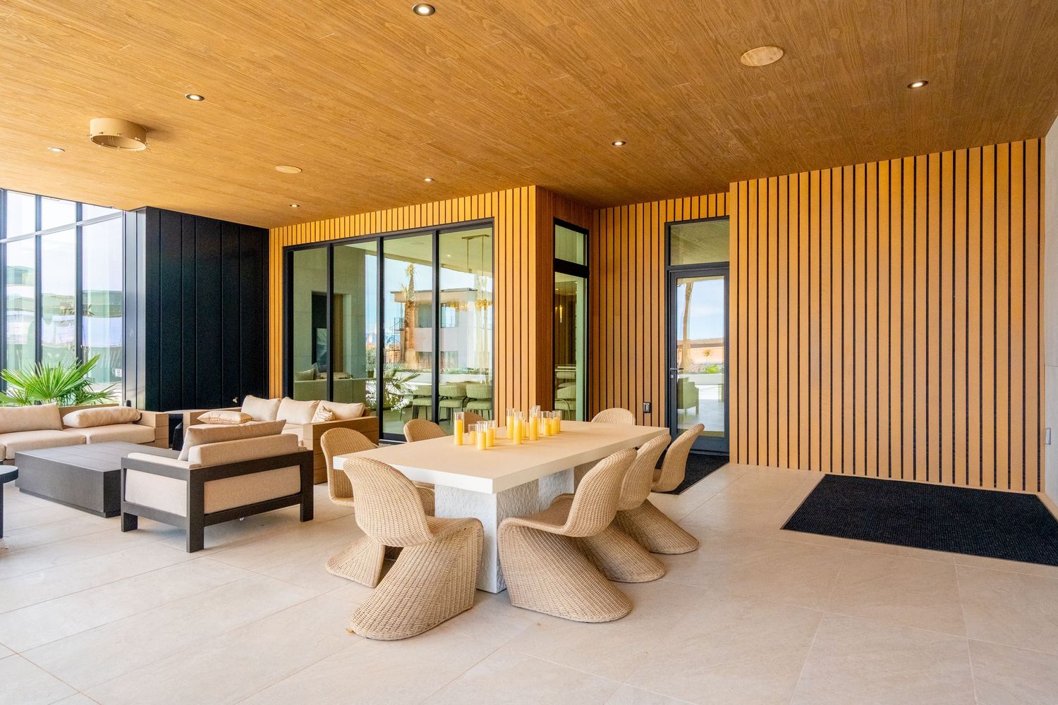 Modern spa relaxation room with wooden walls and comfortable beige lounge chairs in a luxurious wellness center.