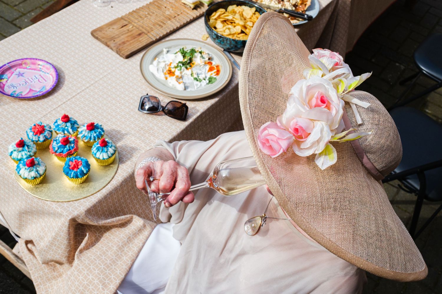 Colorful cupcakes and frosted treats displayed on rustic wooden boards at a dessert table setting at Camden Passage