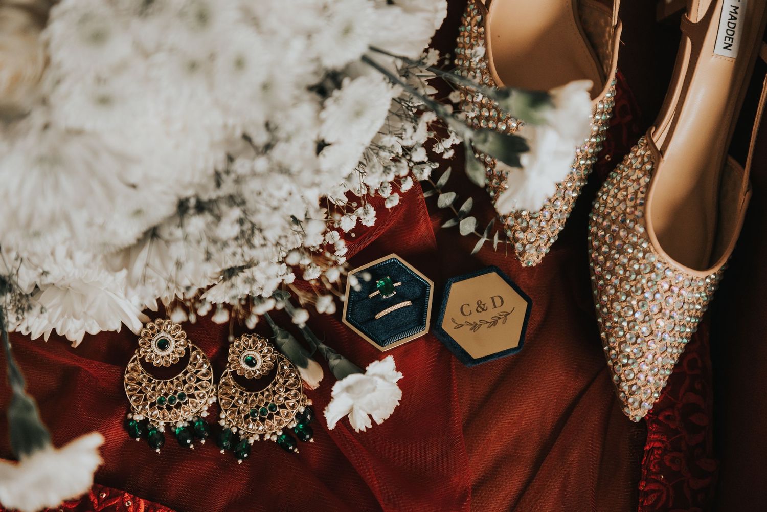 Close-up detail of ornate bridal jewelry and accessories in white and gold tones.