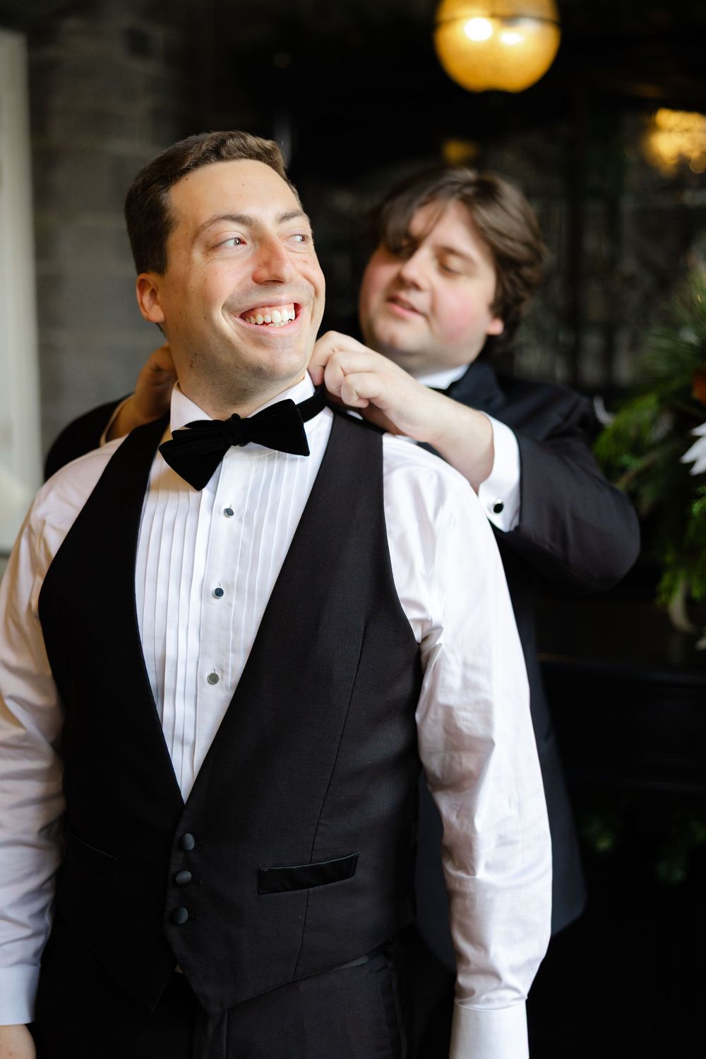 Candid sequence shows joyful moments between two people in formal wedding attire sharing laughter at an indoor venue.