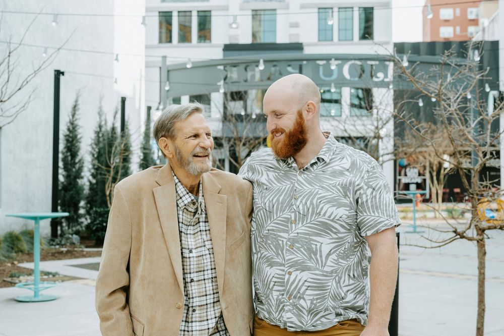 Friends enjoying a casual gathering outside while wearing coordinated neutral-toned outfits.