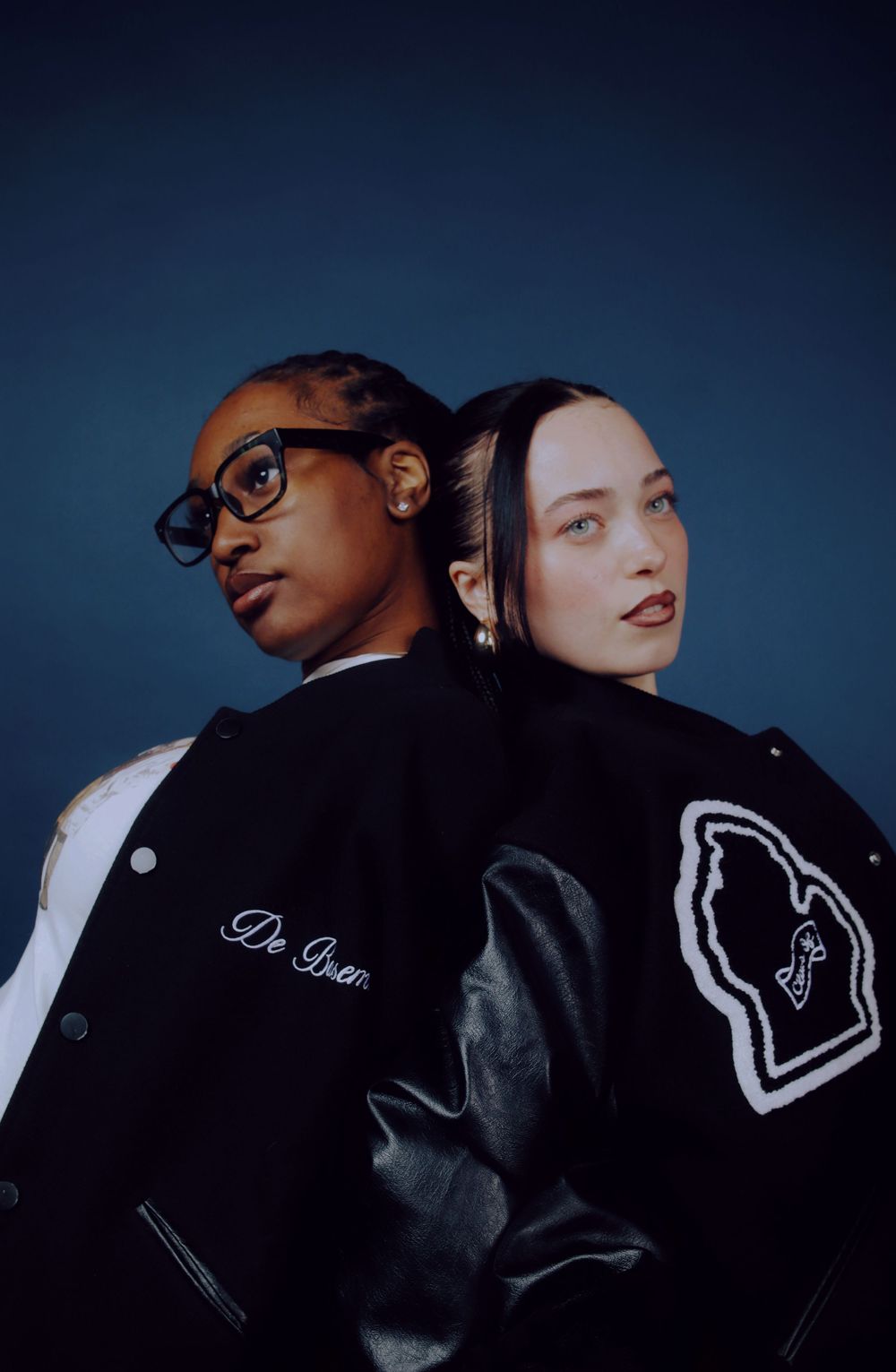A series of artistic fashion photos showing two models in black and white styling against a dark background.