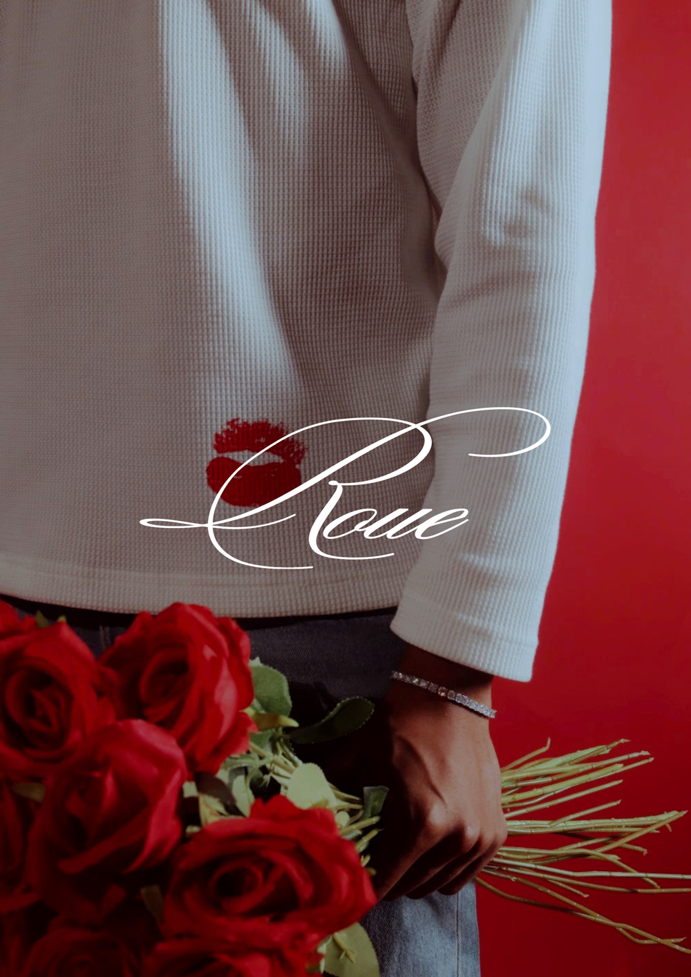 Someone in white sleeves holding a bouquet of vibrant red roses against a dark red background.