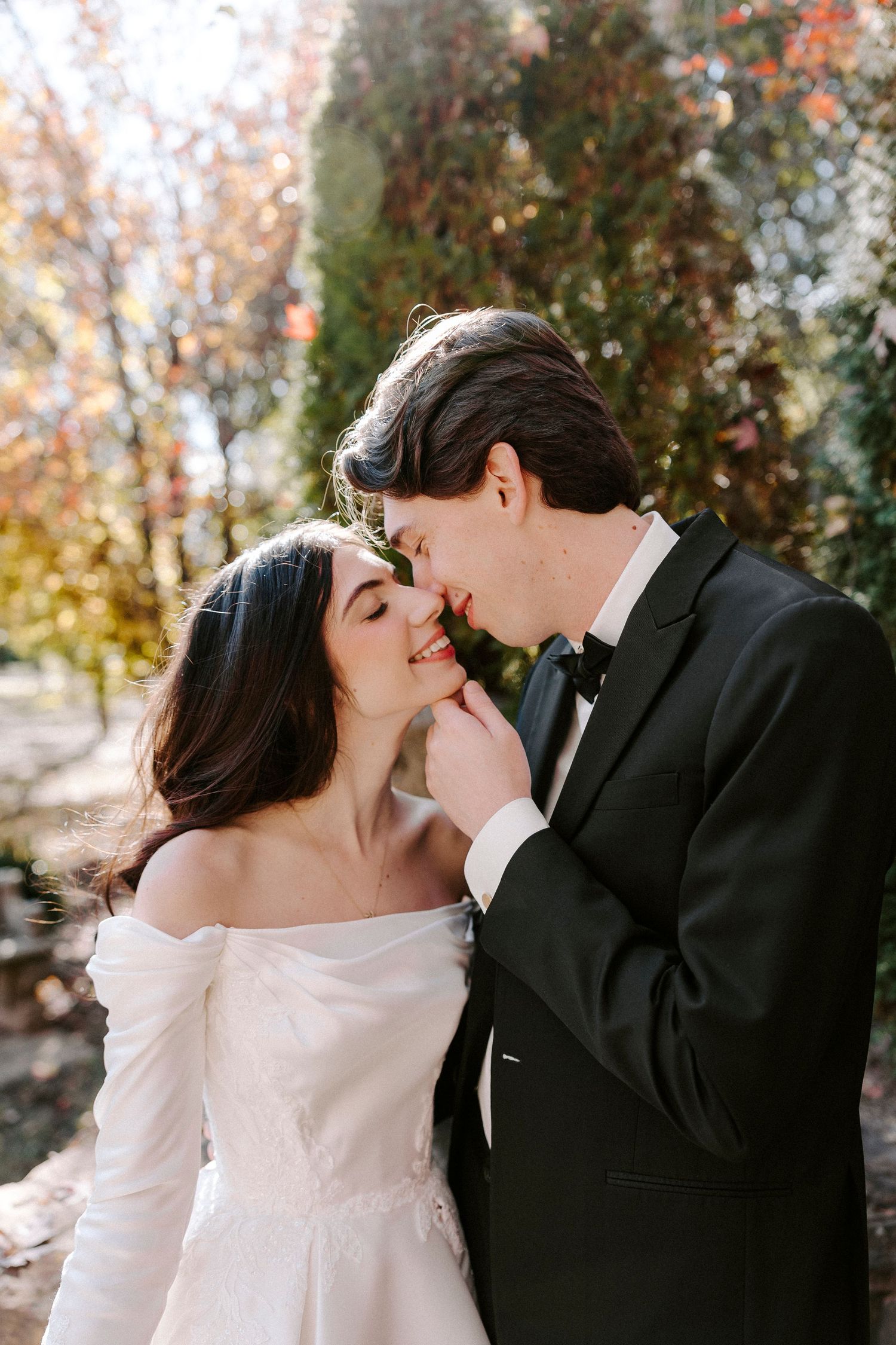 A romantic wedding photo of a couple sharing an intimate moment in the garden at Stone Chapel at Matt Lane Farm.