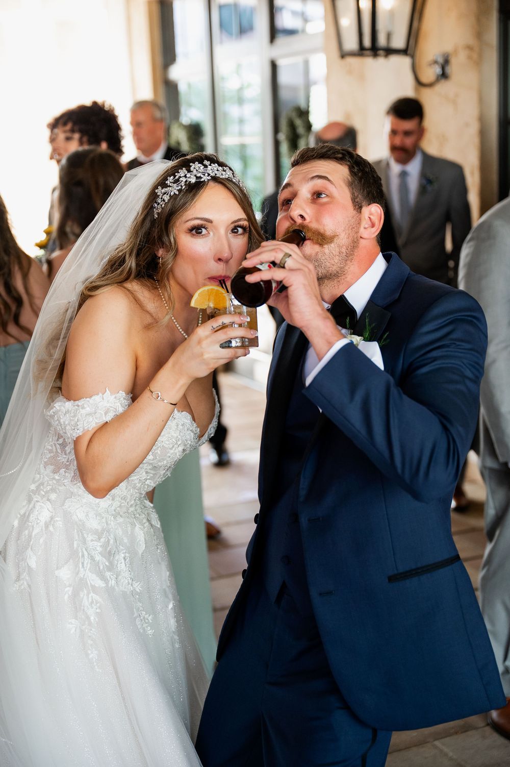 A couple takes celebratory shots together during their wedding reception.