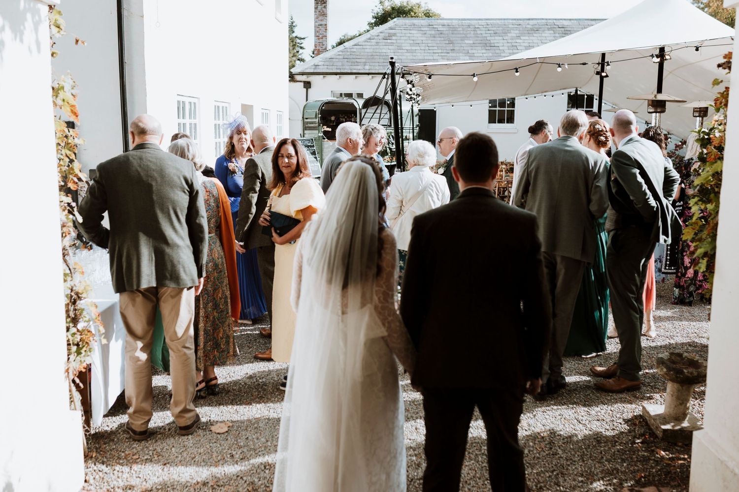 Couple arrives at their wedding drinks reception at Hopton Court