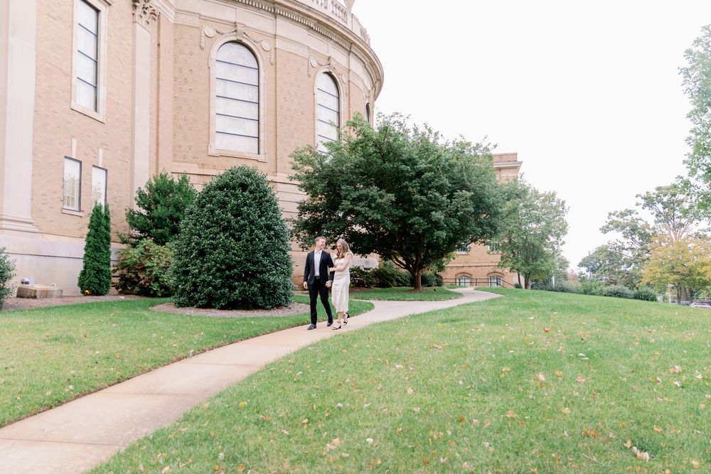 A scenic view of a grand historic building with columns and landscaped grounds.