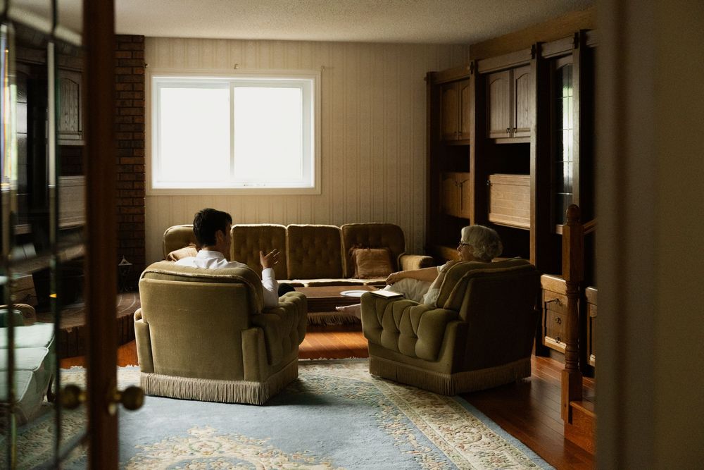 Modern living room interior with large windows and contemporary furniture.