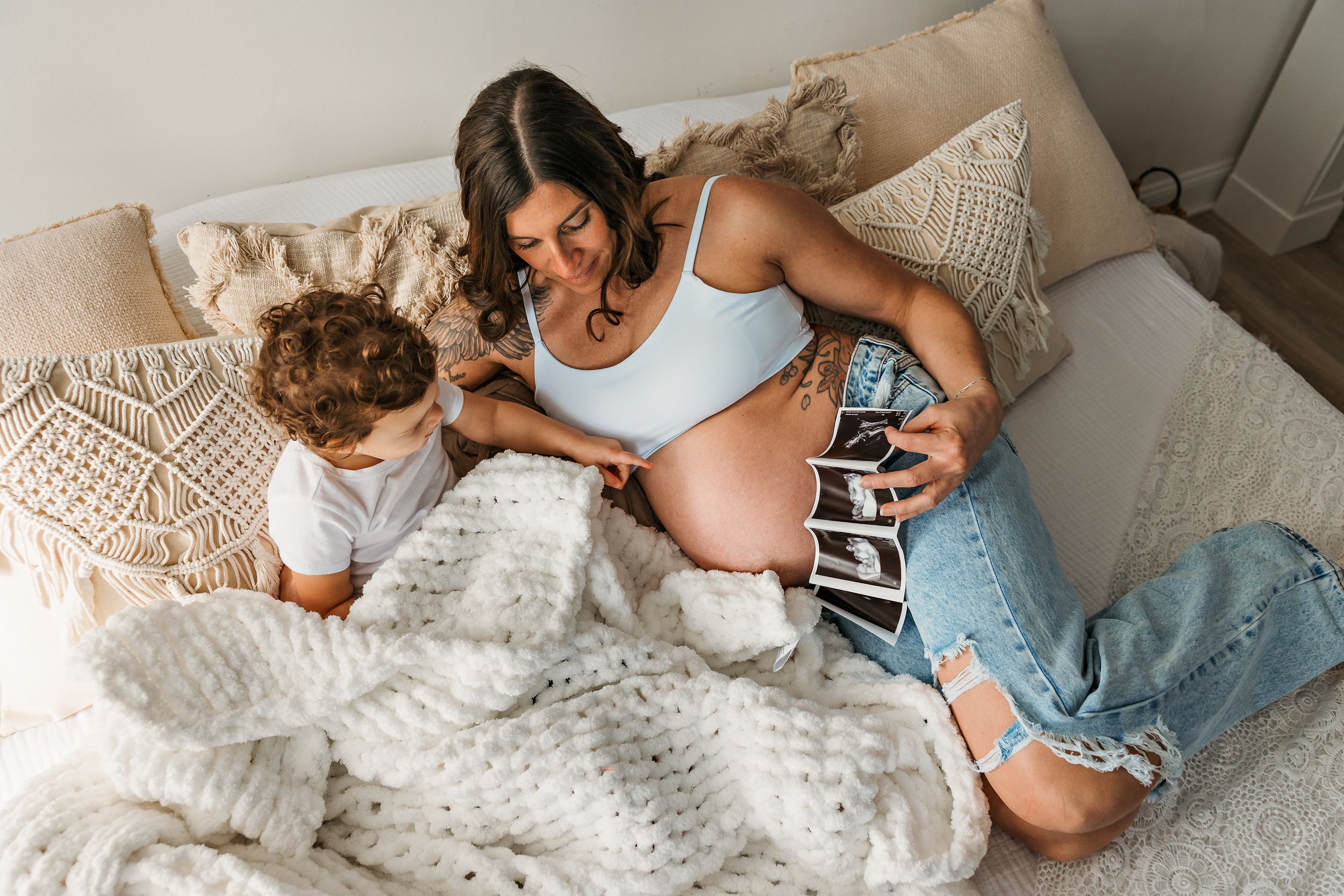 Candid lifestyle photos of family members sharing tender moments on a white couch.