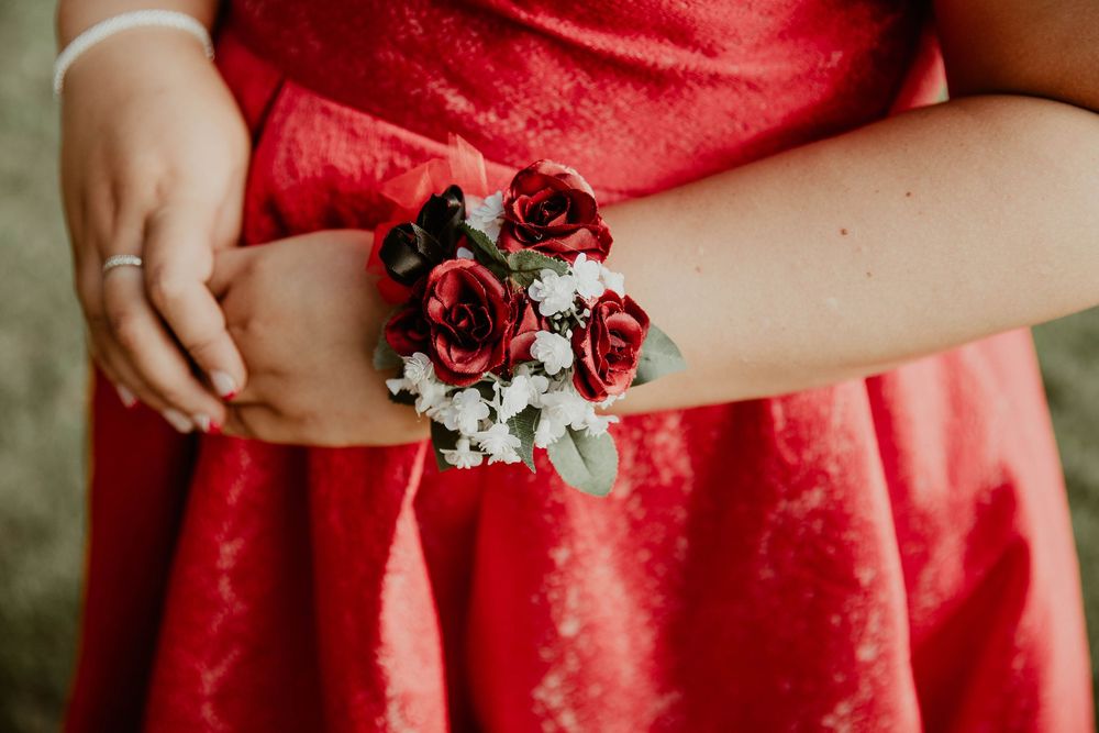 Red corsage on graduate's arm