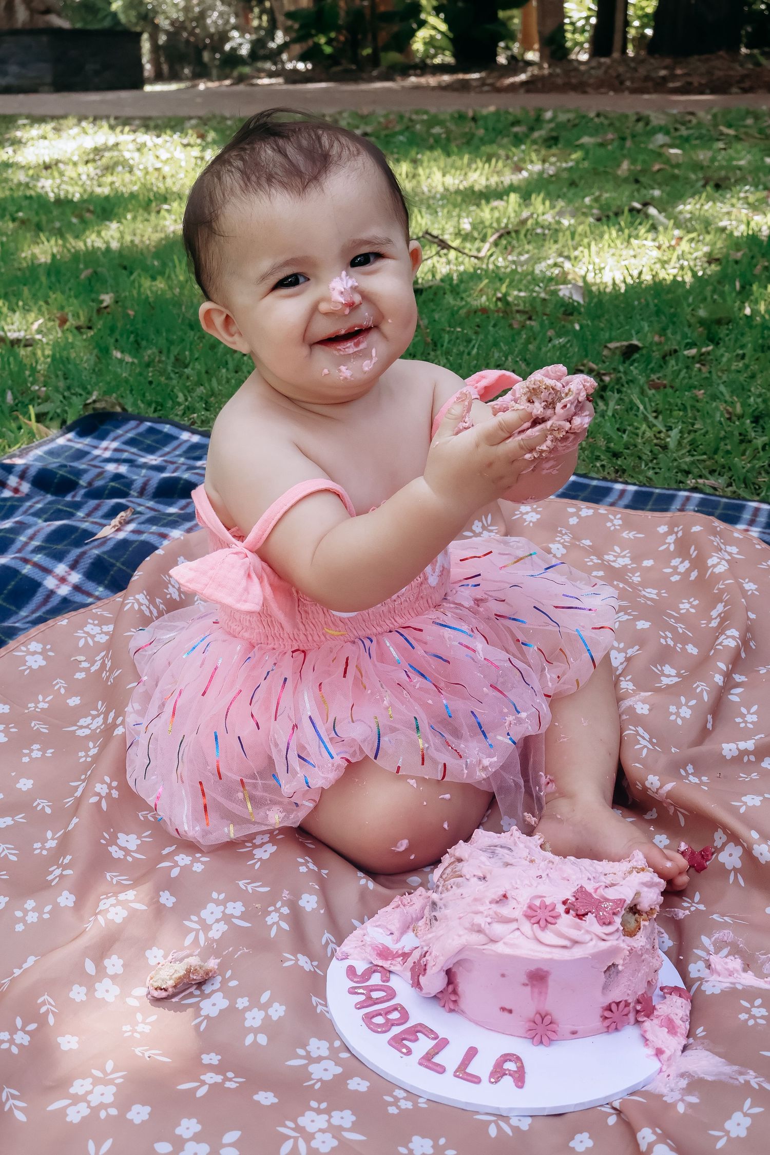 Cake smash photography documenting a first birthday filled with mess, laughter, and fun