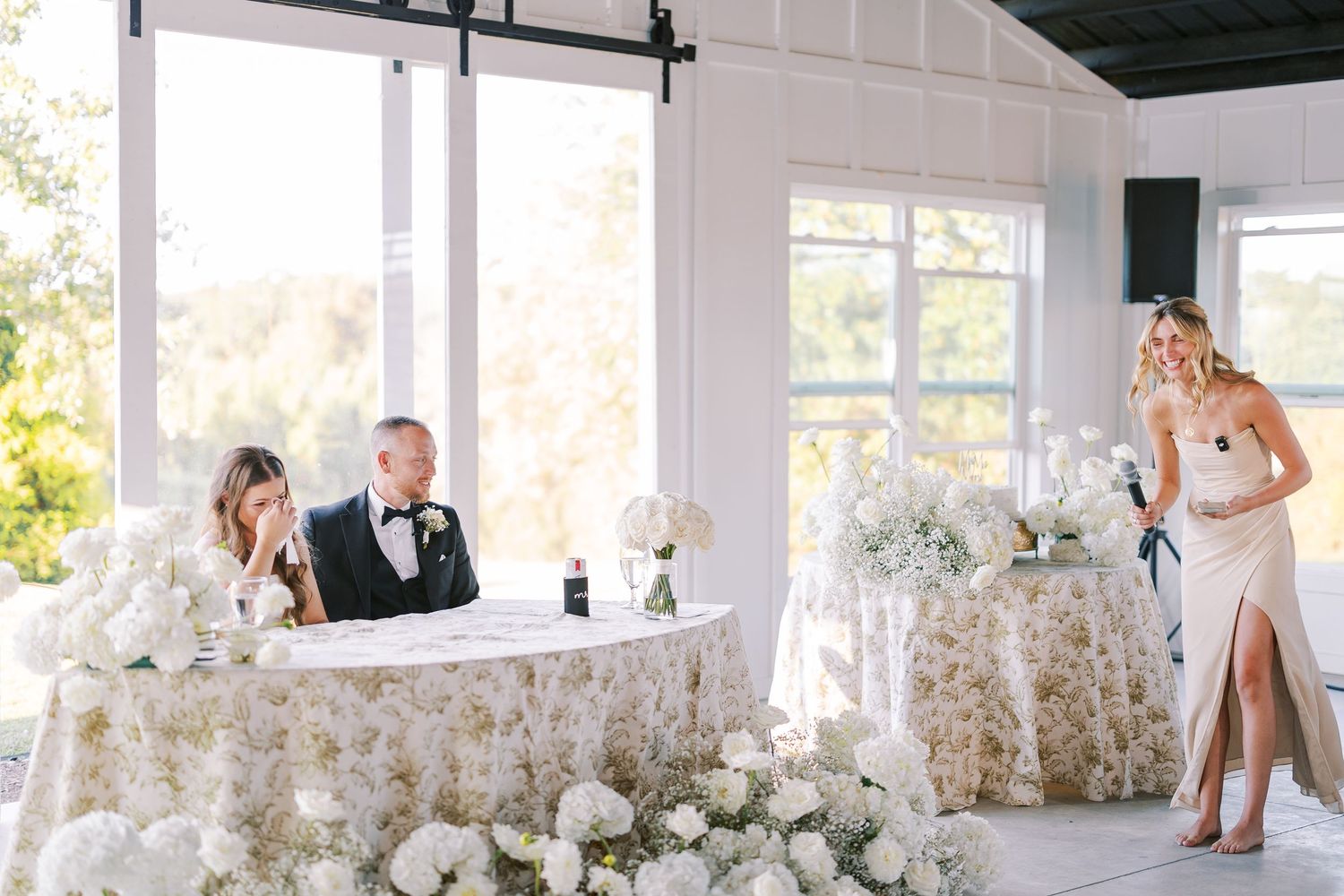 A joyful celebration at a wedding reception shows people dancing and enjoying themselves in a bright venue.