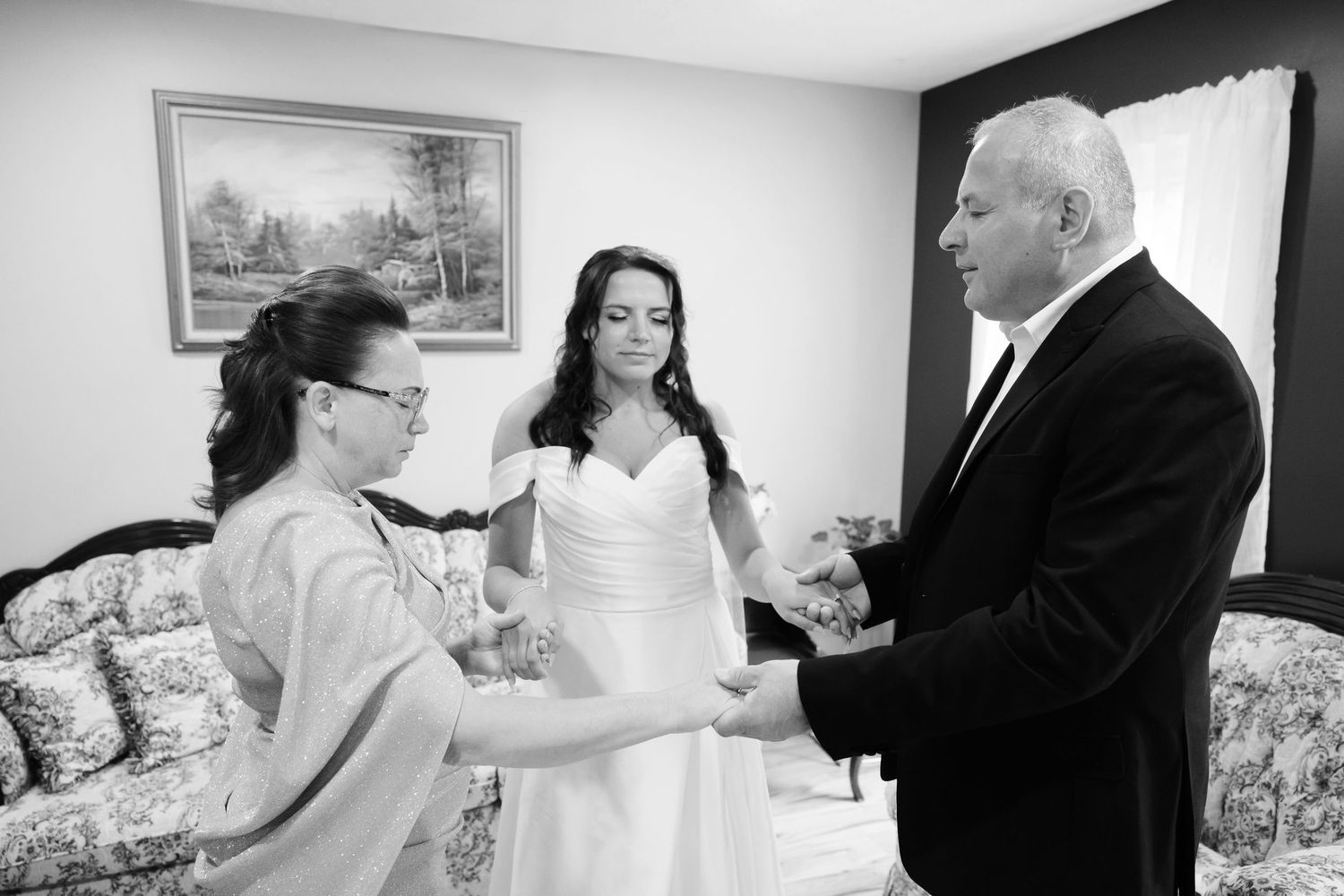 Ohio bride praying with her parents on wedding day.