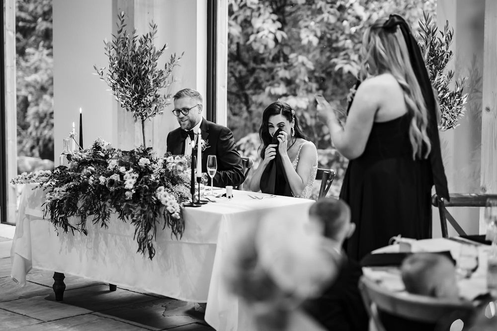 Black and white wedding photos show intimate moments between couples and guests during an elegant reception celebration.