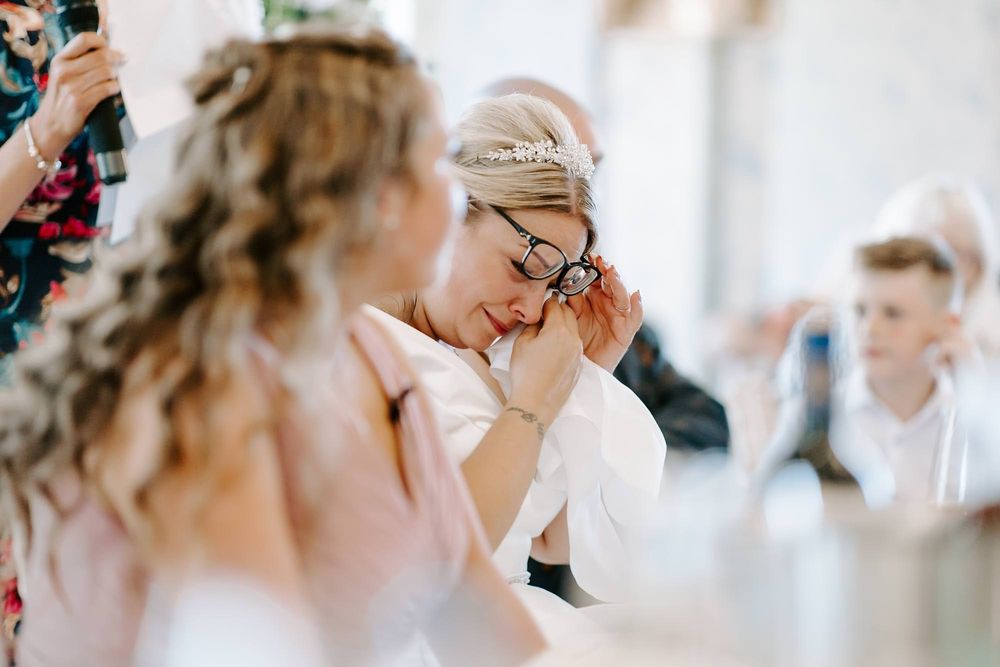 Candid moments of laughter and celebration captured during a bright, airy wedding reception.