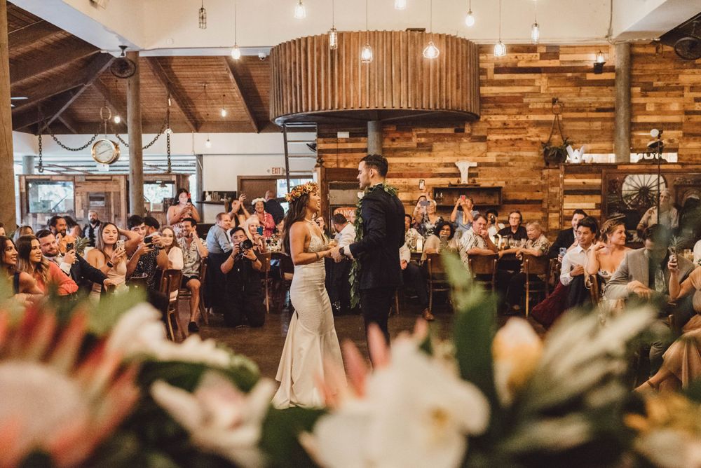Rustic wedding venue interior with wooden walls and decorative lighting features.