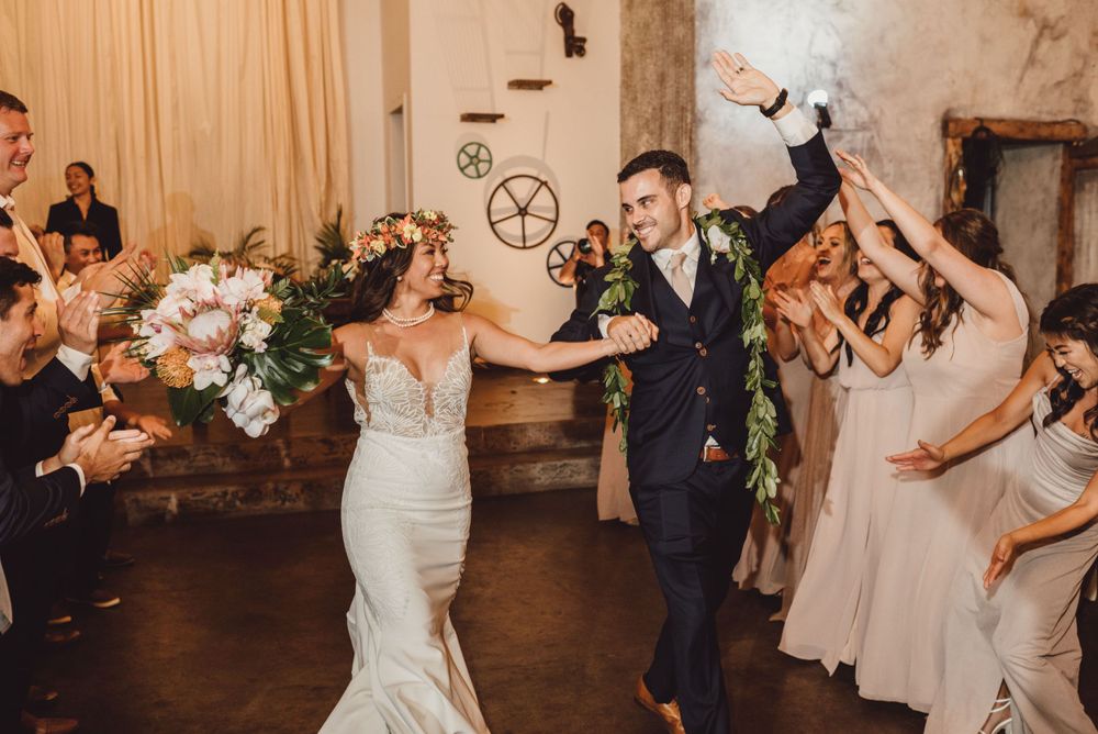 Wedding couples and guests dancing together in an elegant indoor venue.