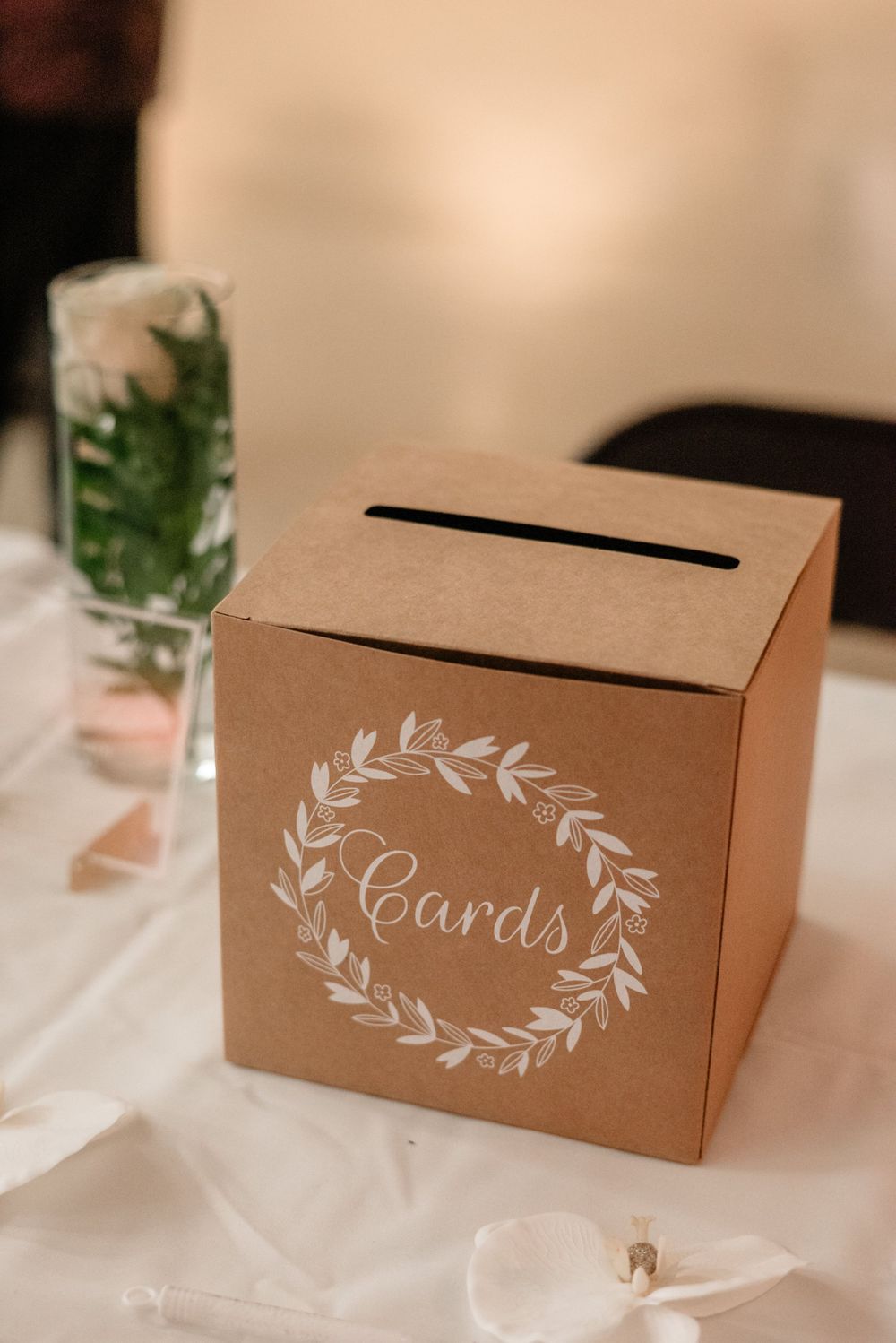 Rustic kraft paper card box with elegant white floral wreath design for wedding cards.