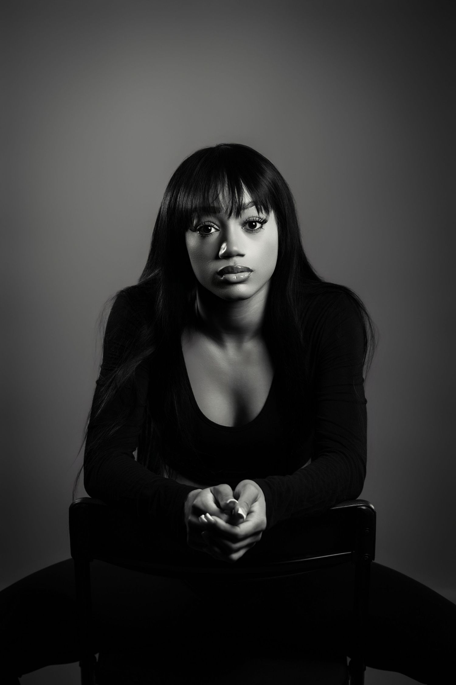 Artistic portrait series showing a person in white bralette and denim against dark background in different poses.