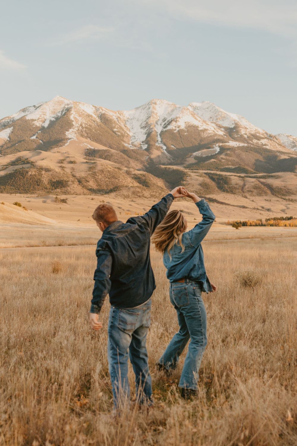 Montana photographer captures a couple dancing under the mountains near Livingston, Montana. Captured by western photographer near Pray