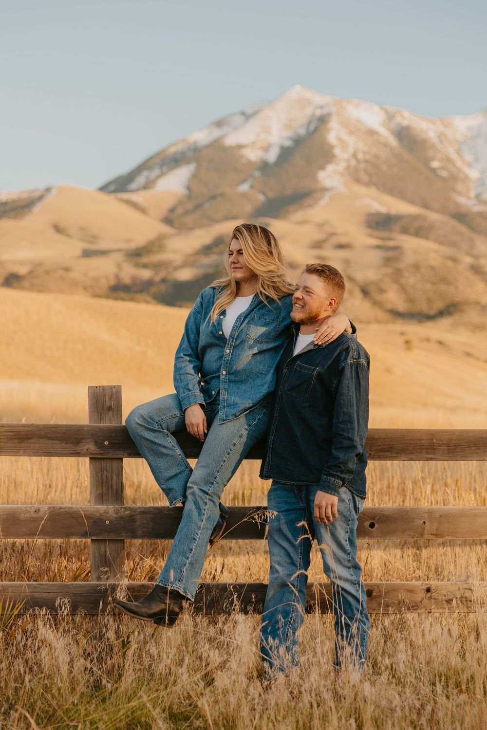 Montana Wedding Photographer captured western couple leaning up against the fence under the Paradise valley Mountains in Pray, Montana