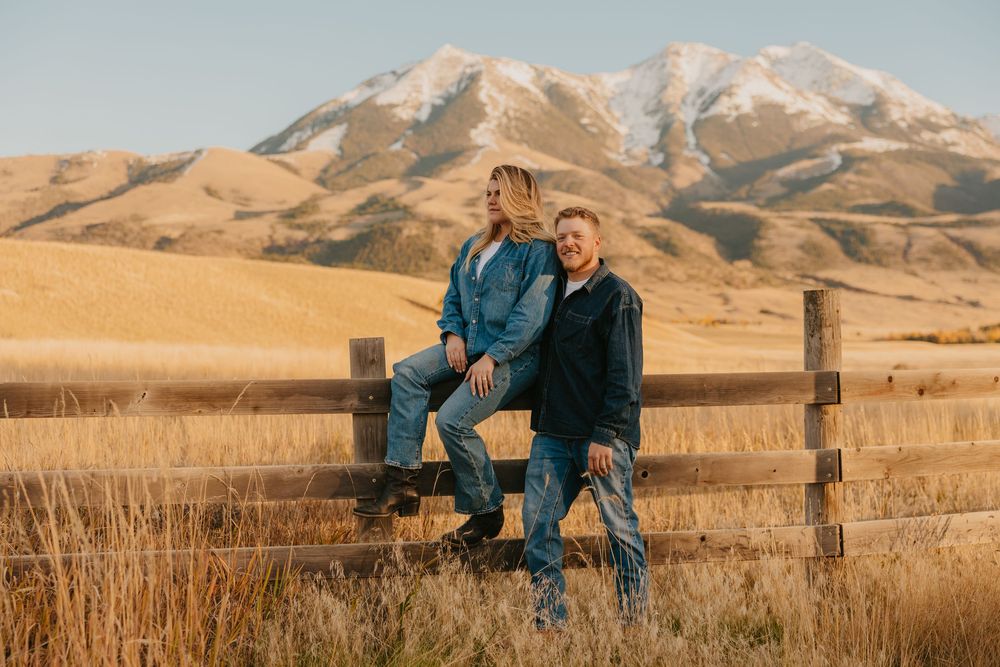 Montana Wedding Photographer captured western couple leaning up against the fence under the Paradise valley Mountains in Pray, Montana