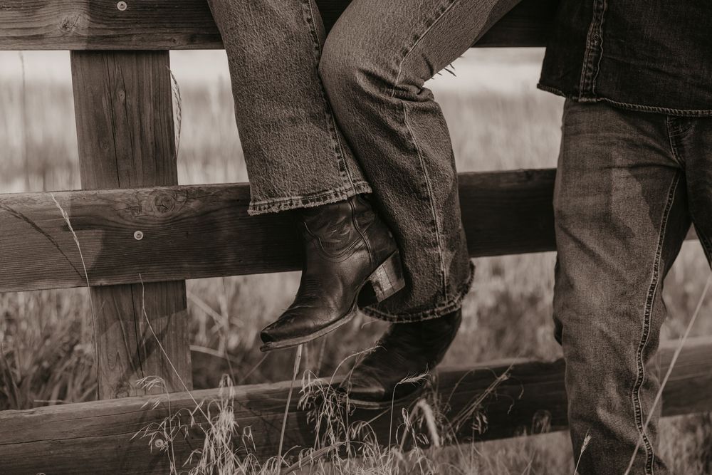 Montana Wedding Photographer captured western engagement session details of boots against a fence Paradise valley Mountains in Pray, Montana