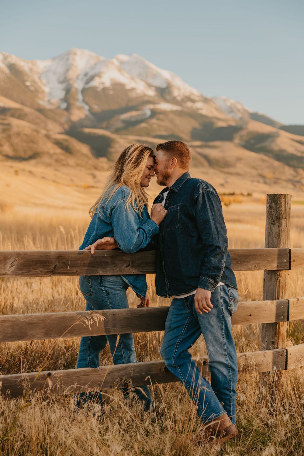 Montana Wedding Photographer captured western couple leaning up against the fence under the Paradise valley Mountains in Pray, Montana