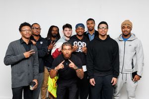 People posing together against a white background wearing casual streetwear.