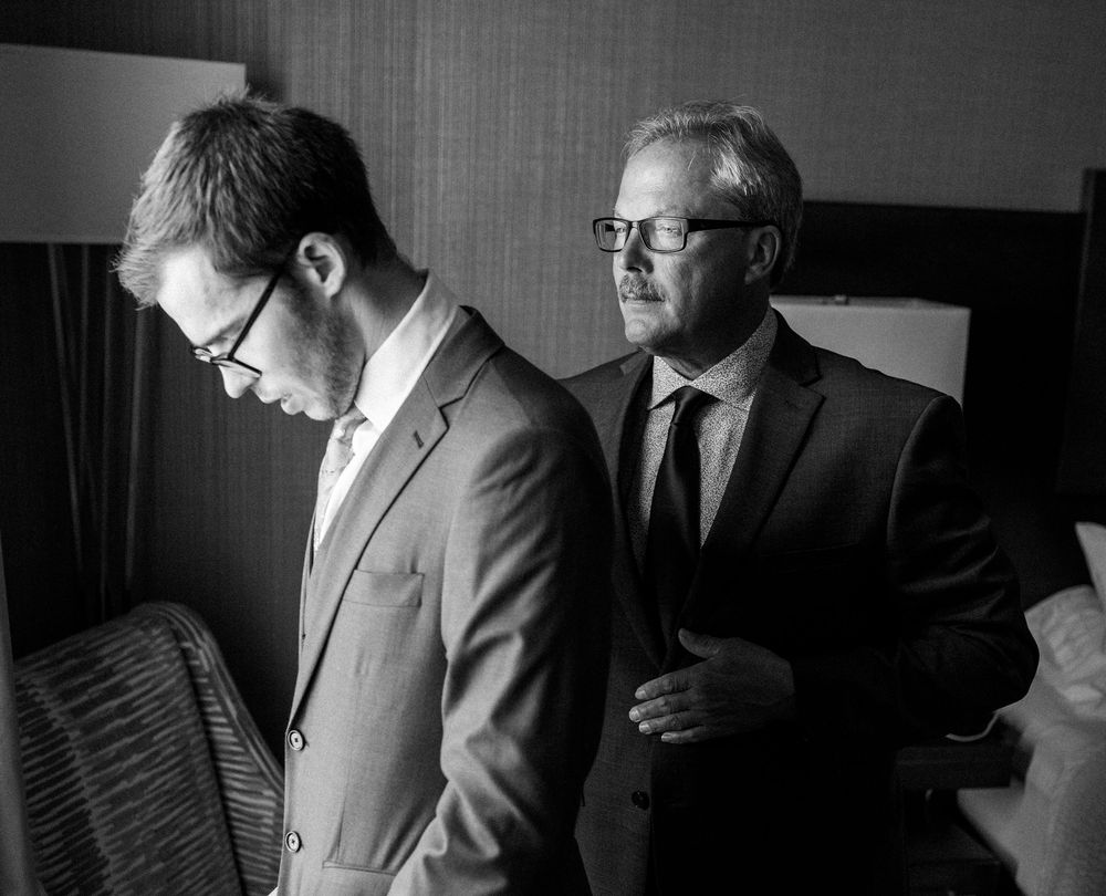 Dramatic black and white portraits of men in formal attire getting ready.