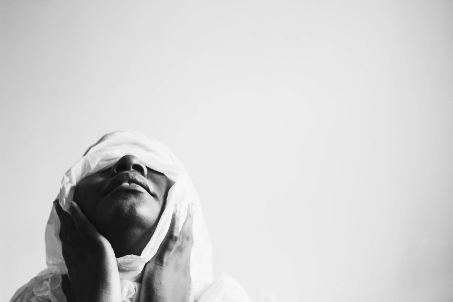 Black and white artistic photo series showing intimate moments of pregnancy and maternity in dramatic lighting.