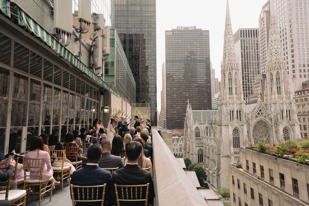 A wedding venue rooftop terrace overlooking New York City skyscrapers and St. Patrick's Cathedral.