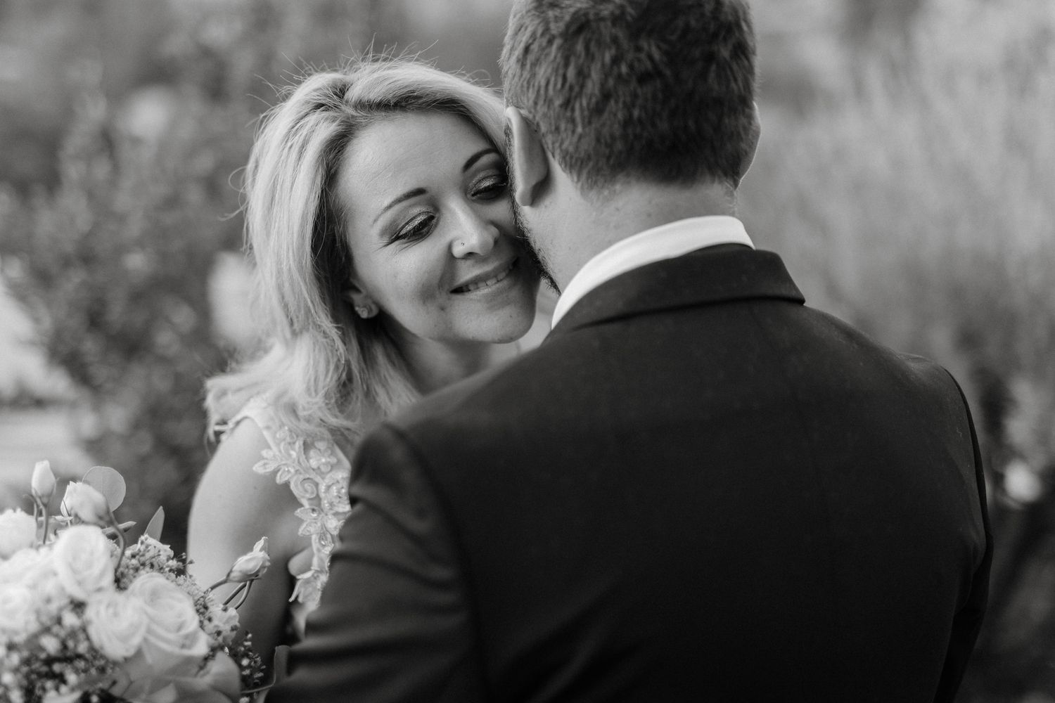 A couple in wedding attire share intimate moments in a black and white photo sequence.