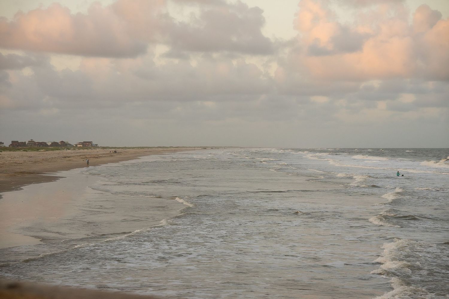 Waves rolling onto the shoreline at Matagorda Beach, Texas during a calm coastal evening