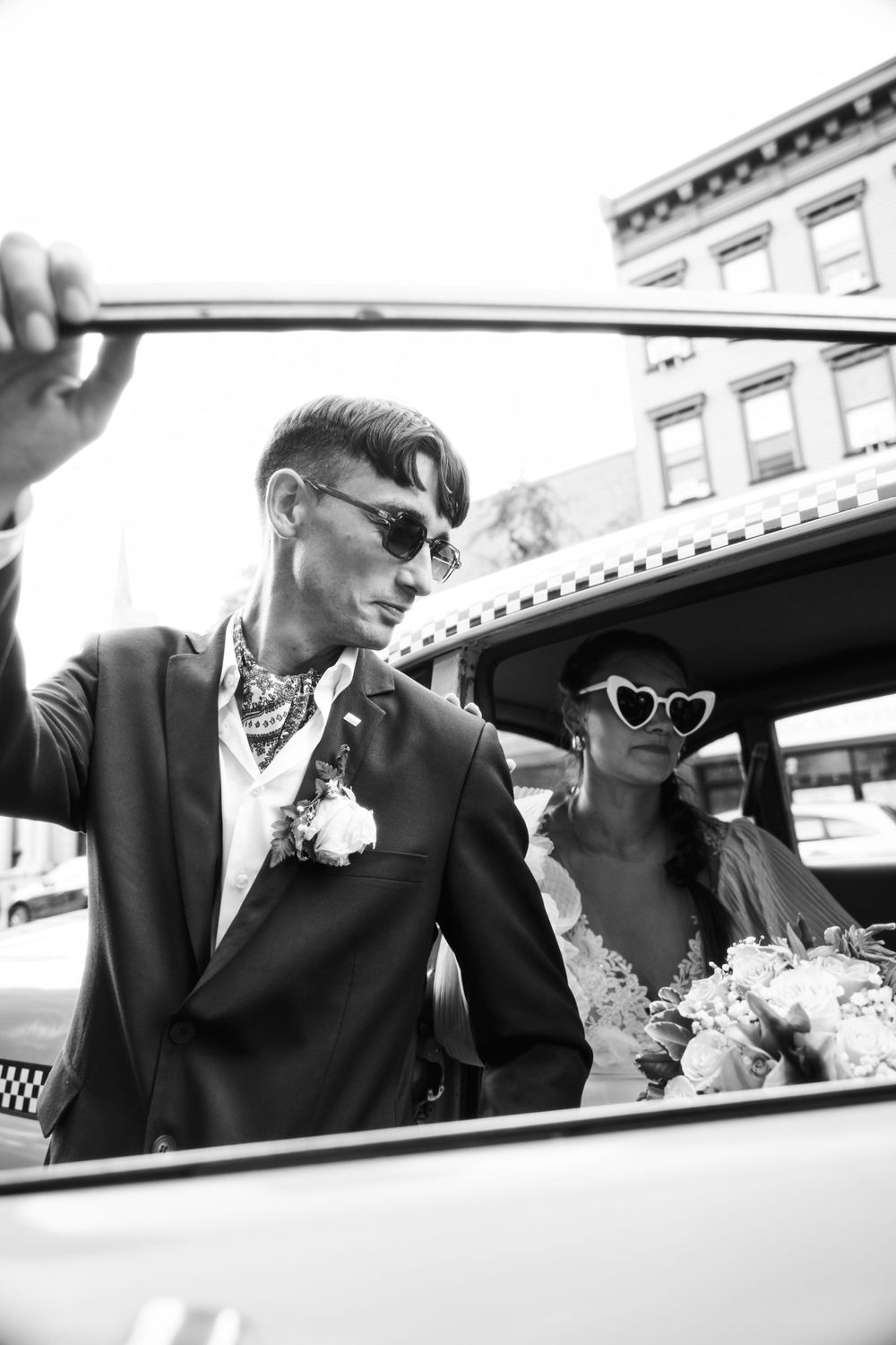 Artistic black and white wedding photos with couple by vintage taxi cab.