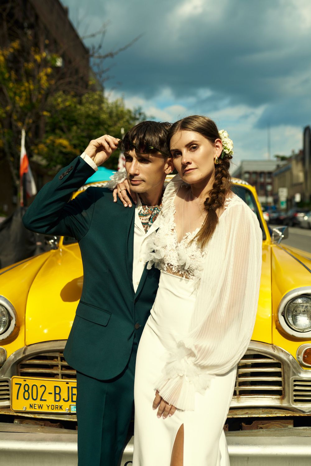 Retro-styled wedding portraits with yellow checker cab in background.