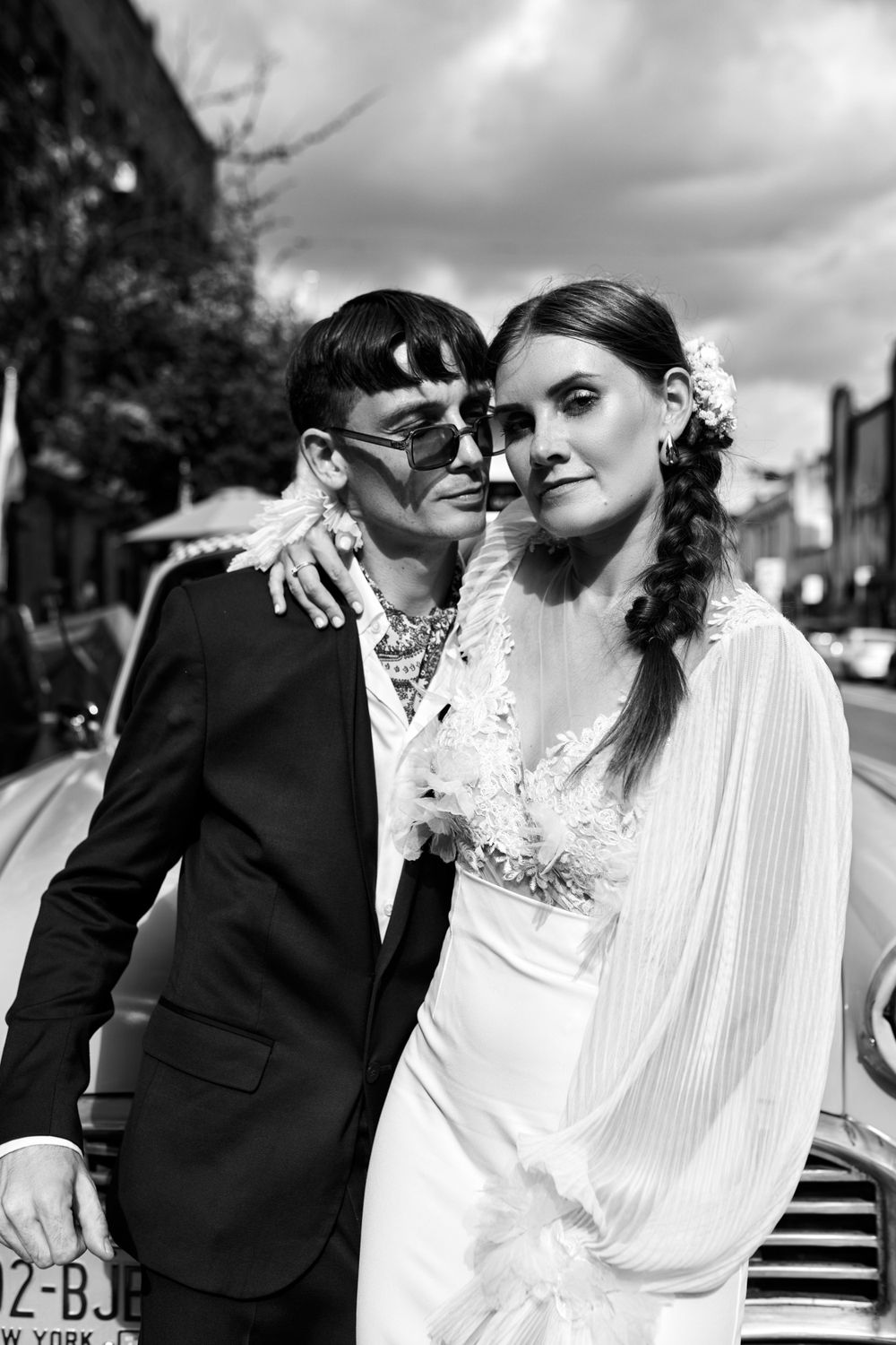 Black and white wedding portraits showing intimate moments by classic taxi.