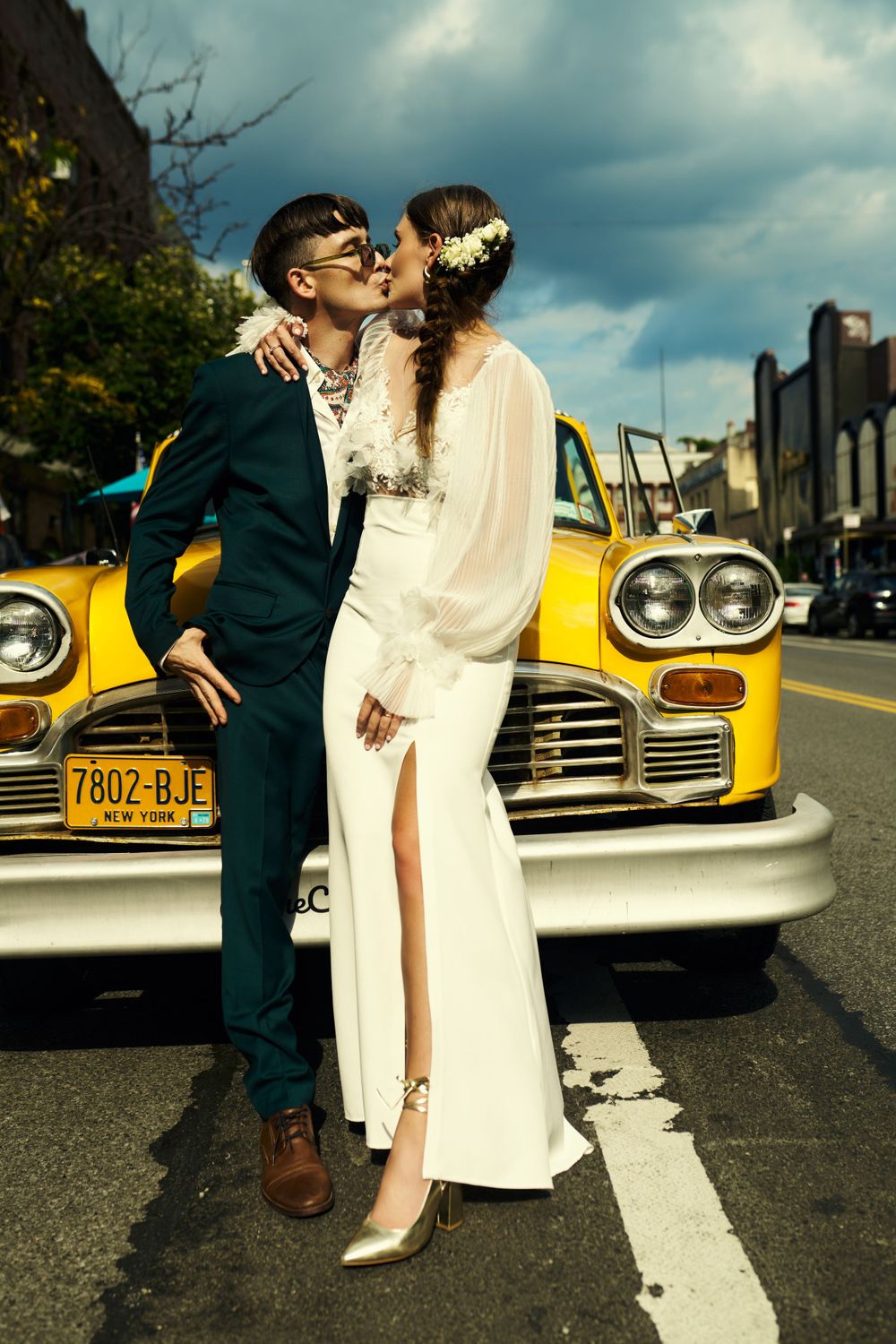 Artistic wedding photography sequence with vintage yellow taxi cab in urban setting.