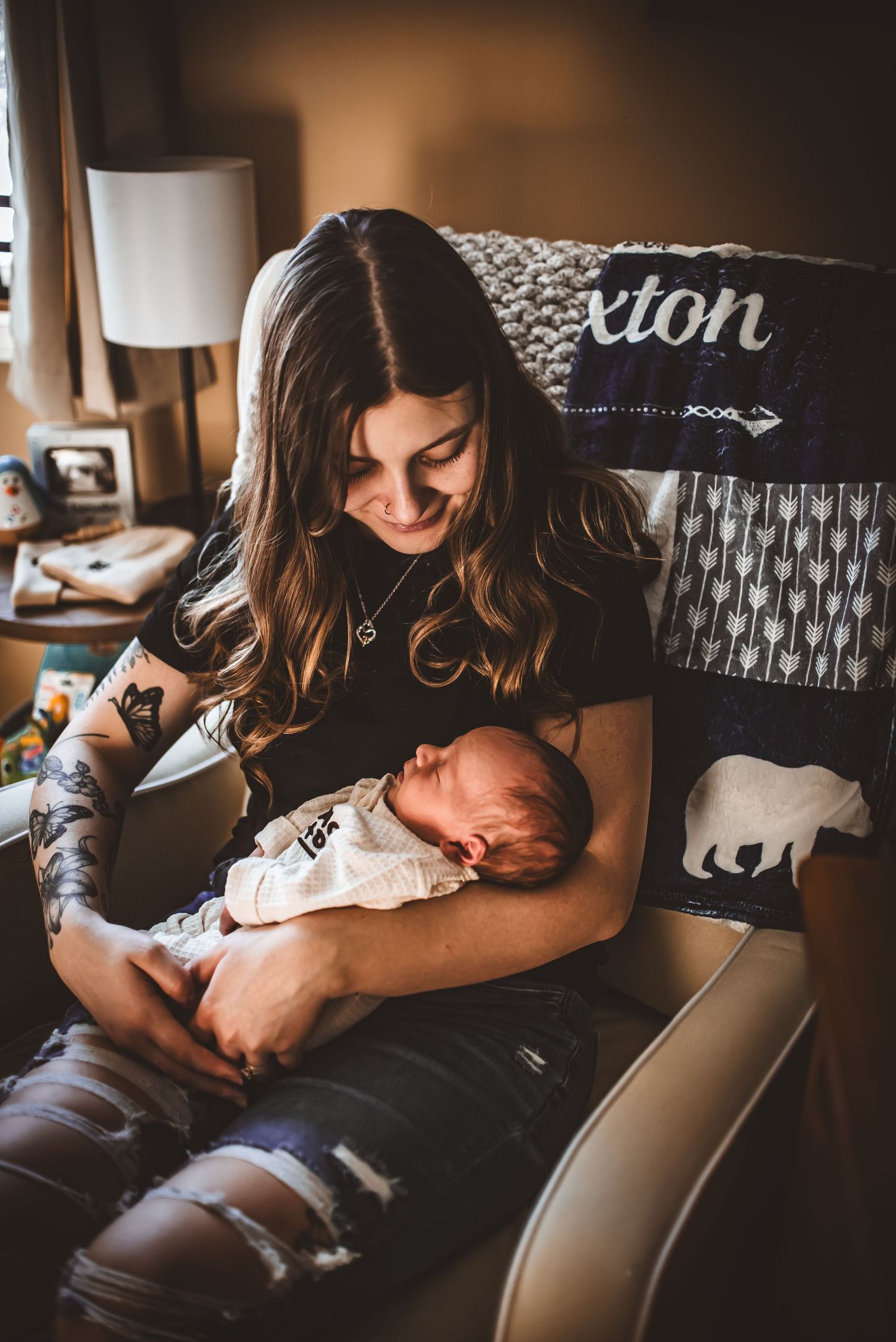 A tender moment between parent and newborn baby in a cozy home setting.