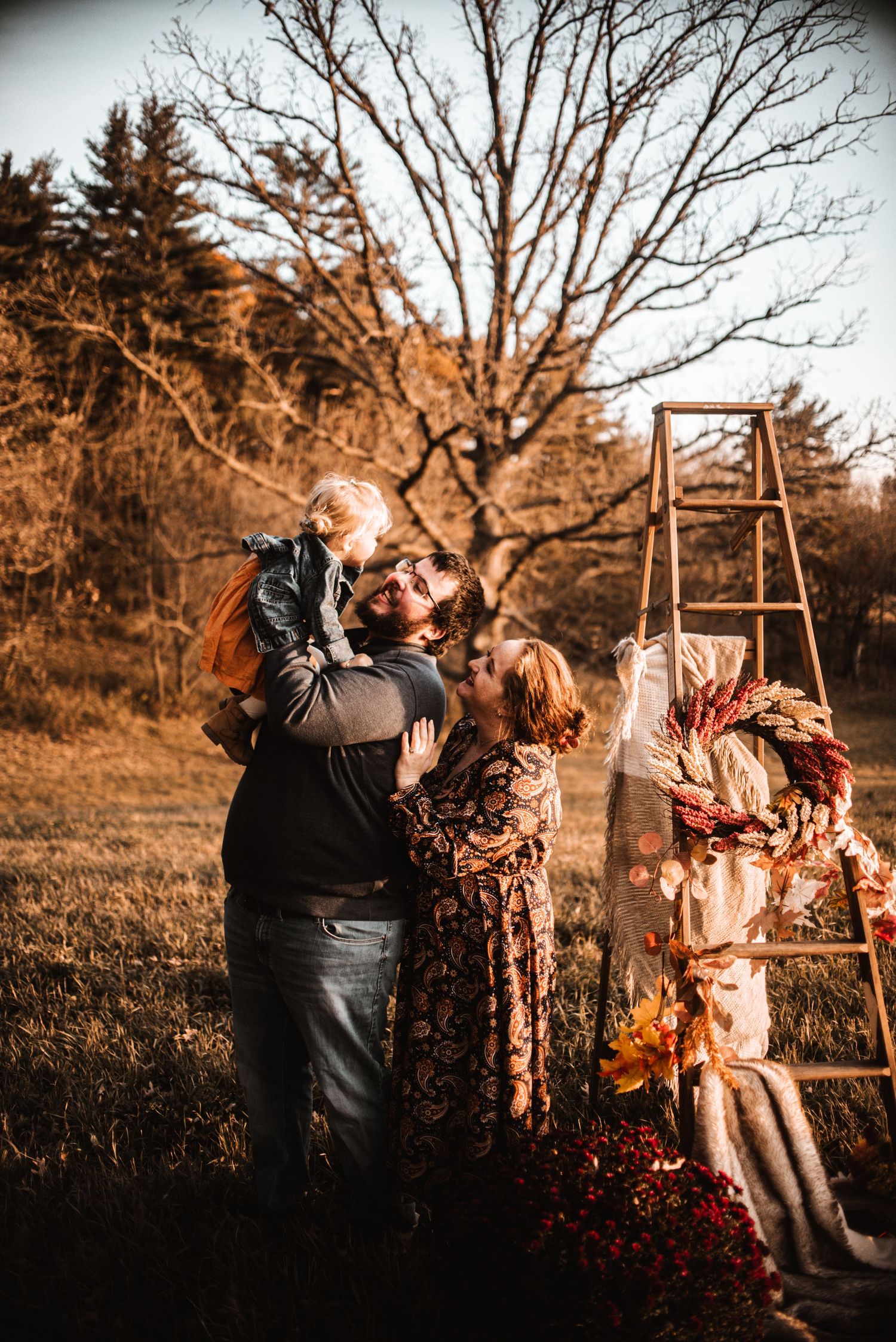 Rustic autumn outdoor photo with wooden ladder and decorative fall elements in warm sepia tones.