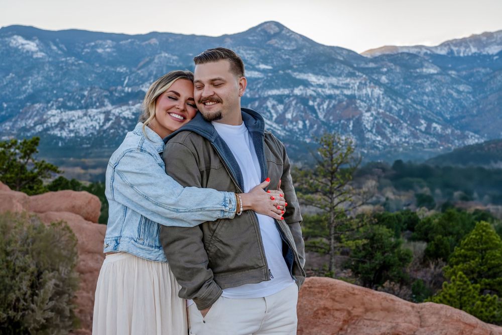Joyful moment captured against mountain backdrop at Garden of the Gods.