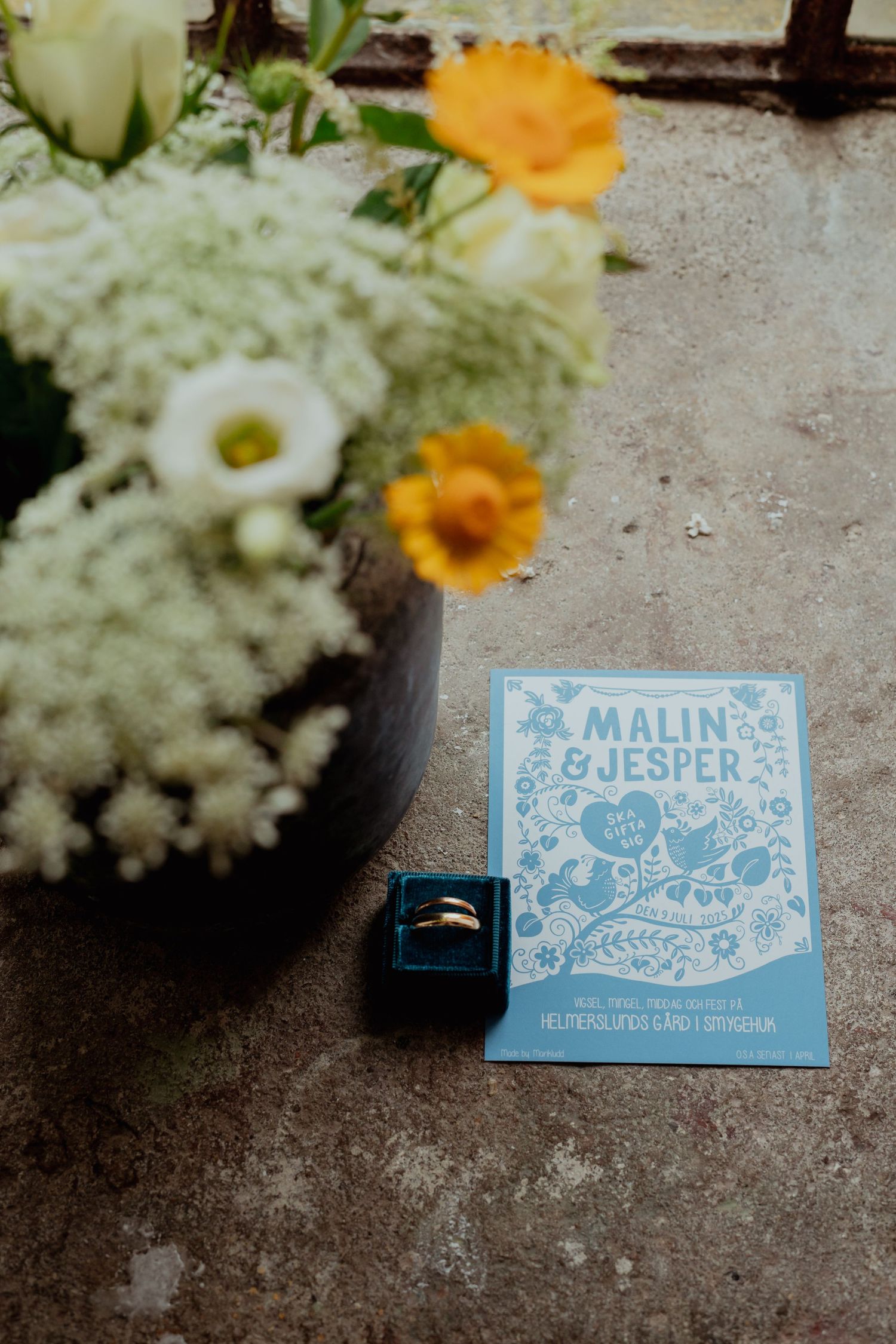 Blue and white place cards with names displayed among delicate floral arrangements.