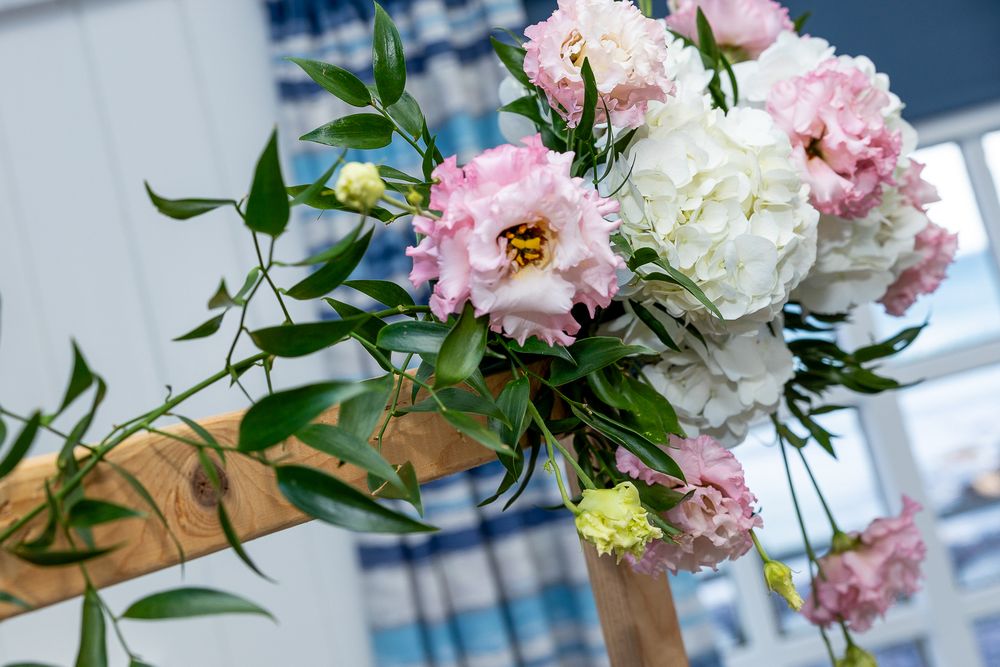A beautiful bouquet of pink peonies and white hydrangeas with green foliage.