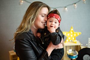 A tender moment shared between parent and baby with a glowing star light decoration in the background.