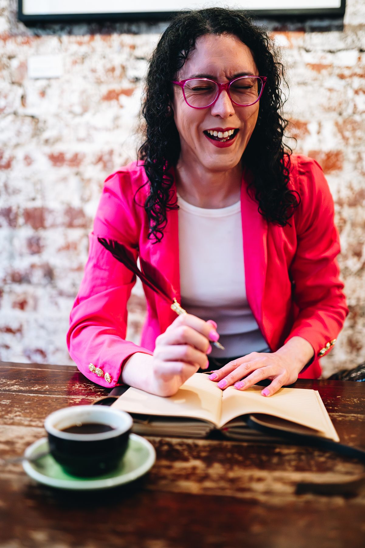 Melbourne branding photo of writer in red blazer and pink glasses with coffee and notebook—perfect for lifestyle and food styling photograph