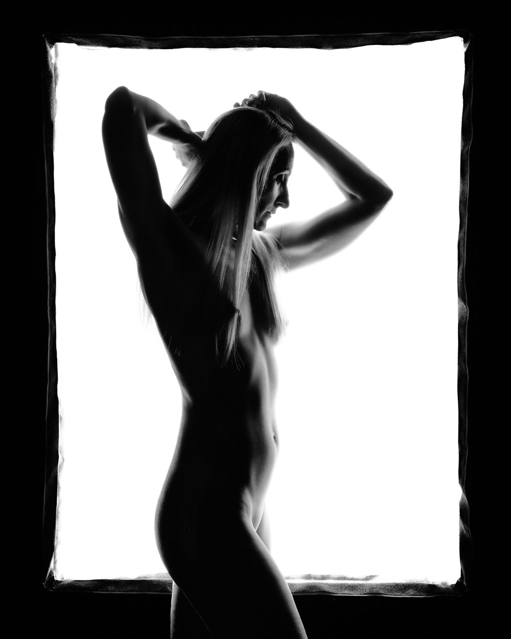 David G Holt Photography - High contrast silhouette study against bright white background showing curves and form.