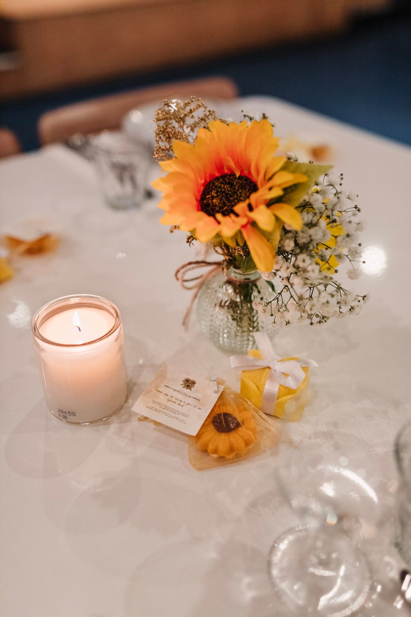 Wedding reception table decor features delicate sunflower centerpieces with baby's breath and white tea lights during Amsterdam wedding