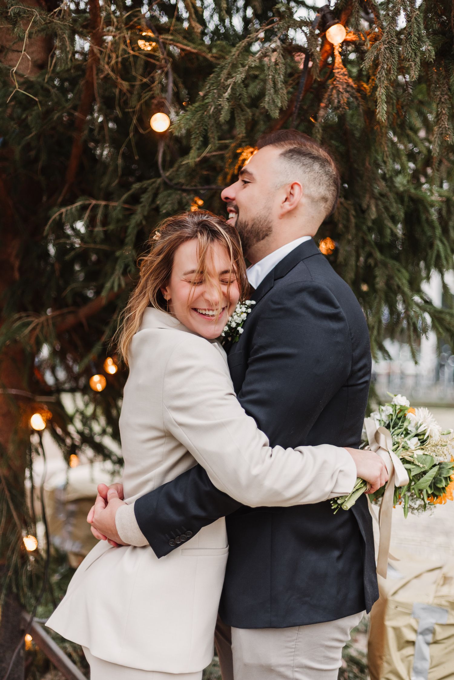 Newlyweds portrait in front of a tree with fairy lights - December wedding in Amsterdam