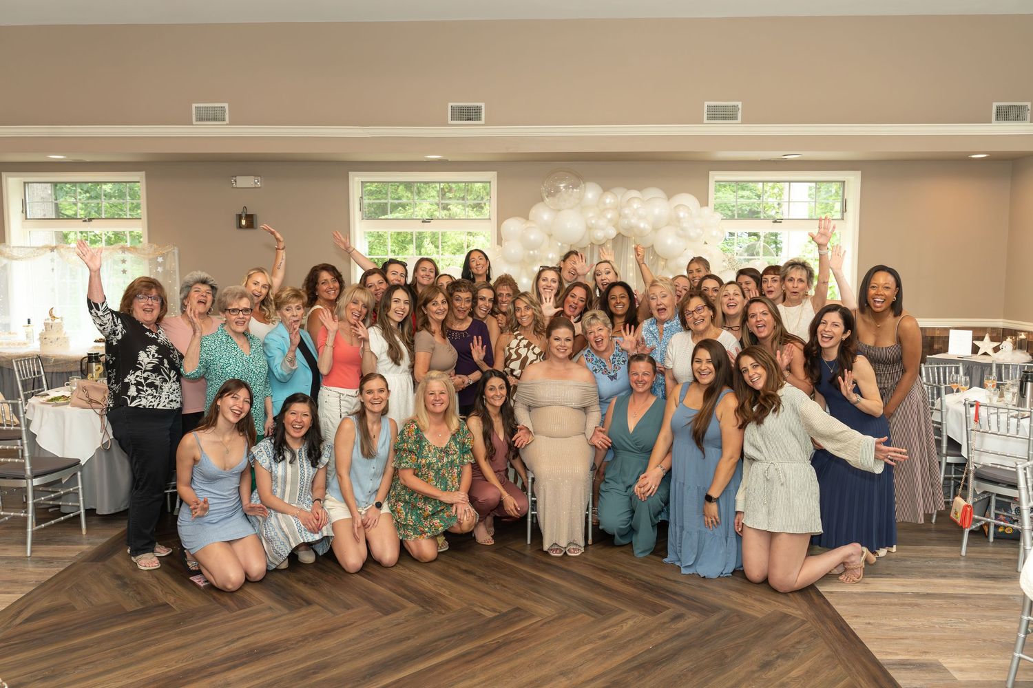 Large group photo of party guests posing for Kim's baby shower